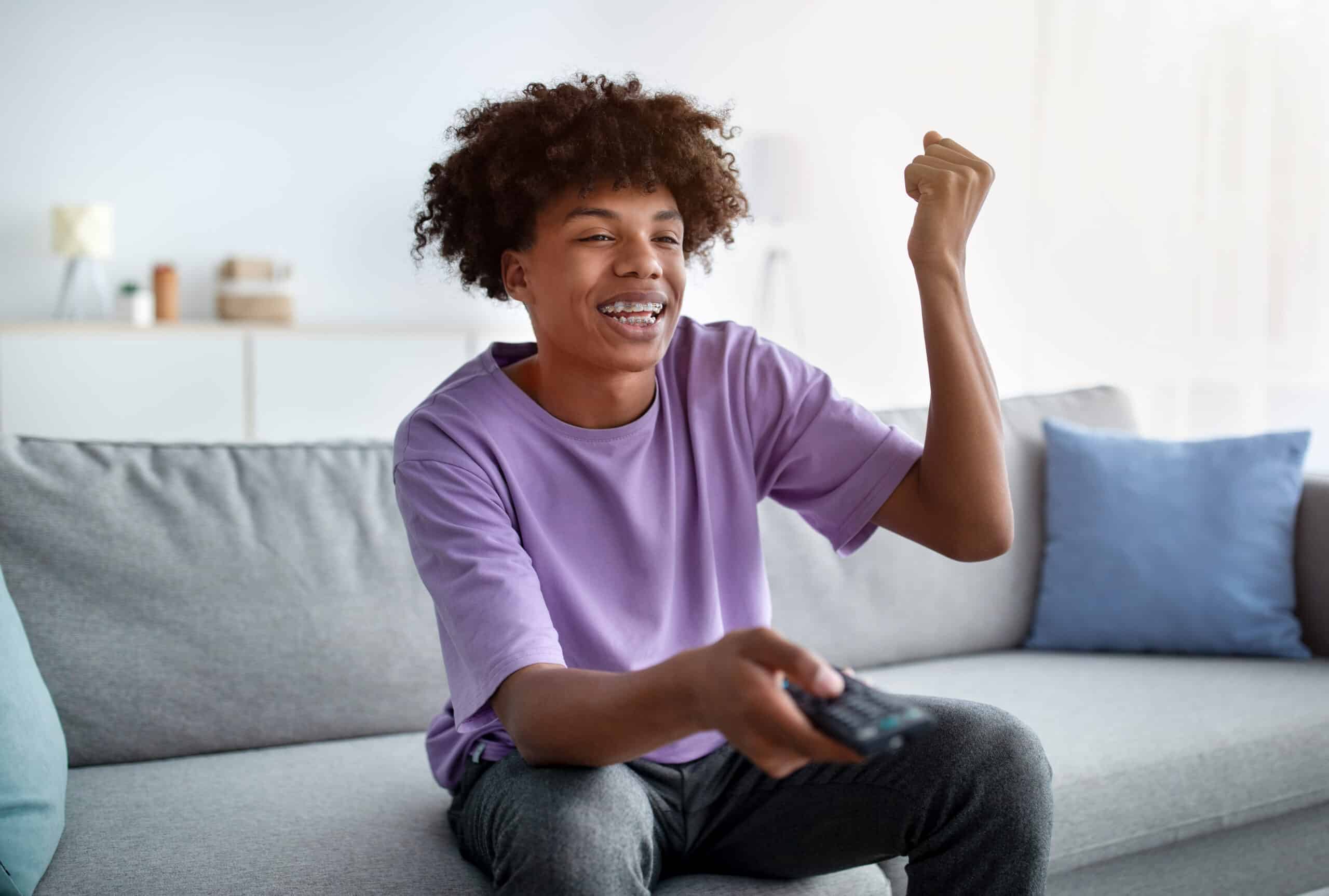 excited african american teen with remote control 2023 11 27 04 53 09 utc scaled